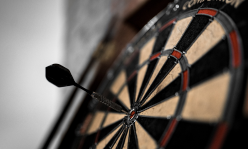 image of a dart board with one dart in it
