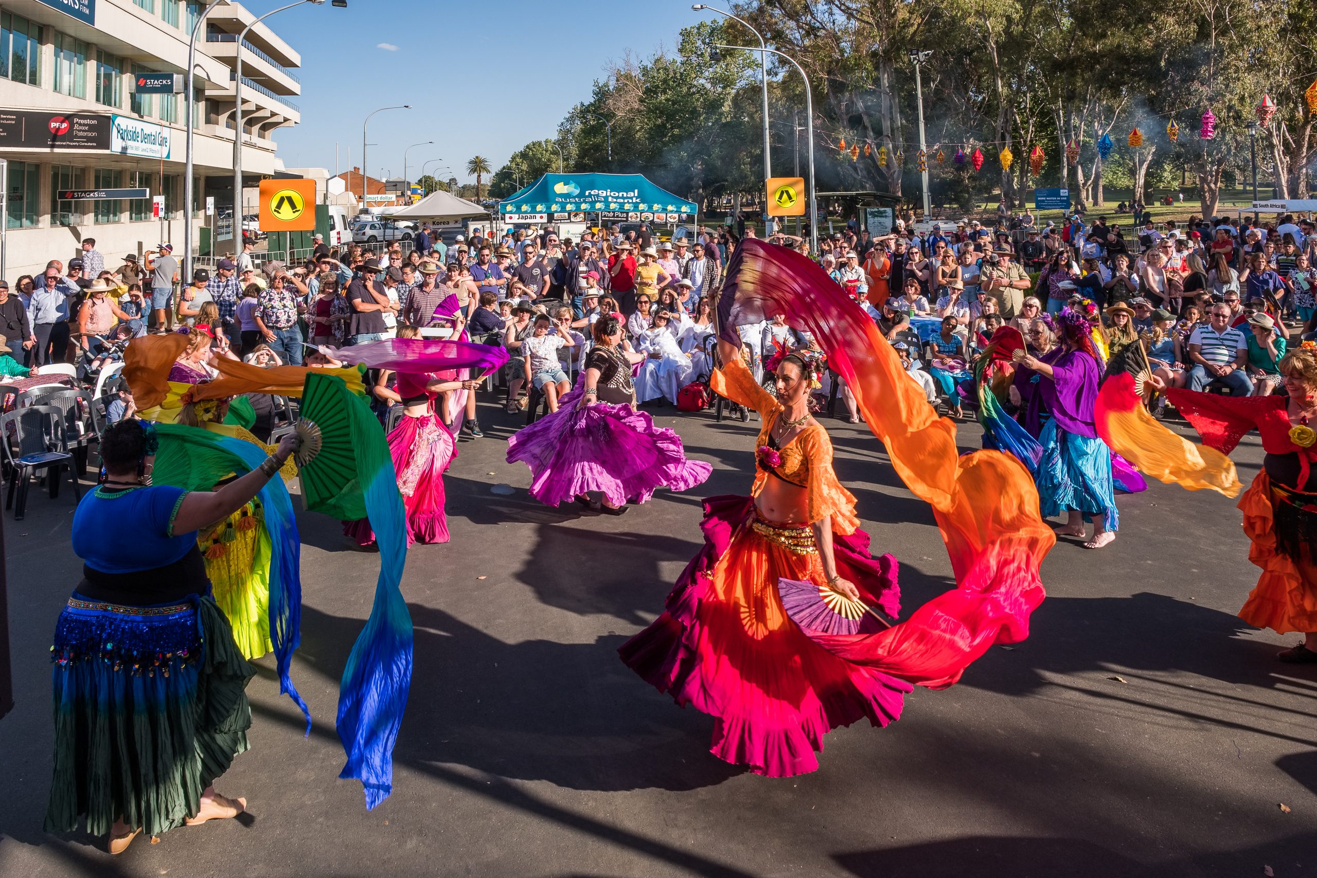 Colourful dressed women dancing and twirling at Fiesta La Peel Tamworth