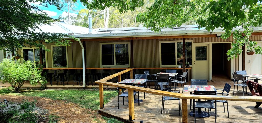 a tranquil garden setting for the entrance and outdoor seating at The Drunken Trout Cafe